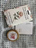 Front view of bath milk packet, candle tin and face mask