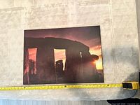Front view of Stonehenge sunset photo on board with tape measure for scale