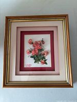 frontal view of framed layered rose artwork
