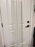 Full view of wire shelf leaning against door