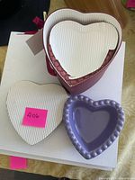 Purple ceramic heart ramekin beside boxed set