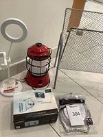 Group shot: Samsung S630 camera box, Barebones lantern, white mini ring light, mesh magazine rack, packaged 5X mirror