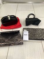 Overall group shot of four clutch purses