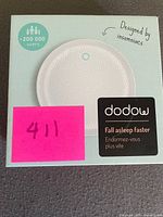 Front view of boxed Dodow sleep aid device
