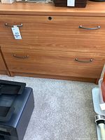 Front view of cabinet showing two drawers and handles