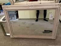 Front view of mirror showing frame design and mirror surface