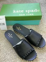 Top view of Kate Spade Zahara black slide sandals with box