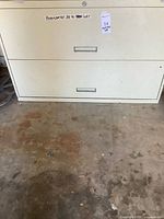 Front view of off-white two-drawer filing cabinet