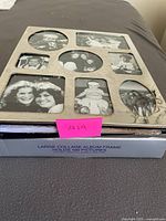 Front view showing silver-tone collage frame cover and original box label