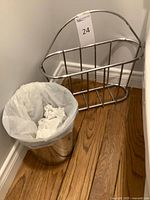 Chrome magazine rack and waste basket shown together