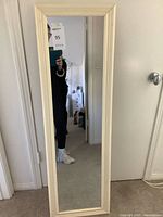 Front view of cream-framed rectangular mirror showing full length and proportions