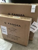 Two sealed Pangea Home boxes containing folding side tables
