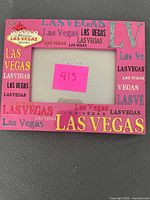 Front view of pink plastic Las Vegas themed 4x6 picture frame showing design and condition