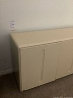 Front left view of ivory Stilglass sideboard showing two doors and finish