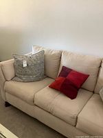 Front view of beige ultrasuede sleeper sofa, showing cushions