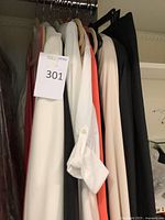 Multiple garments hanging on closet rod in various colors