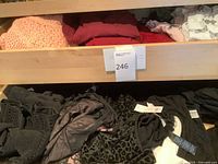 Shelf with multiple folded tops in assorted colors and prints