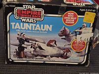 Front of box showing 'The Empire Strikes Back' branding, Tauntaun illustration and 'open belly rescue feature' callout