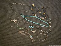 Overview showing various southwestern style jewelry pieces arranged on black textured surface.