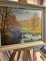 Framed landscape print on easel, full view