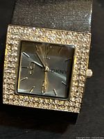 Front view showing square crystal bezel and dial