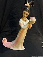 Full figurine side view showing gown and lotus