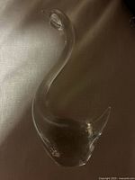 Side view of clear glass swan showing overall form
