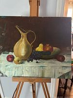 Full view of painting on easel showing entire composition