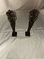 Both cast iron abstract sculptures standing side by side