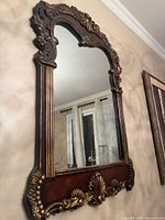 Front view of ornate wall mirror hung on wall