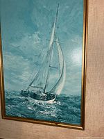 Close-up of artwork showing sailboat and signature