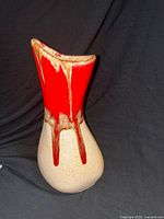 front view showing red drip glaze and overall form