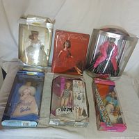 All six boxed Barbie dolls displayed together