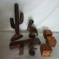 group shot of cactus, bird, three dice, block, horse head, dog figure