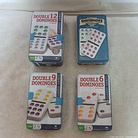 All four domino tins grouped