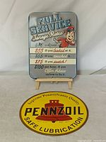 Both signs displayed together on backdrop, showing relative sizes