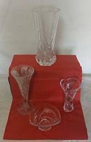 Group shot of four crystal pieces: three vases and one bowl
