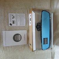 Mirror dash camera in packaging with paperwork