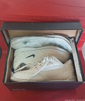 Shoes in repurposed box showing both shoes top view