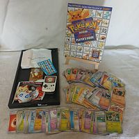 Overview of book, cards spread, kids meal toys and sticker sheet