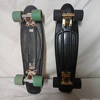 Two 21-inch skateboards side by side showing decks, trucks and wheels