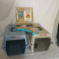 Two Petmate Pet Taxi carriers with treat kit box and puzzle toy displayed