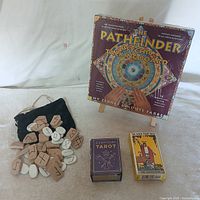 Group shot showing Pathfinder board, two tarot decks, rune pouch and tiles
