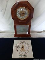 Front view of both clocks: wooden wall clock standing behind Sequoia Grove tile clock