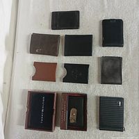 All wallets laid out plus Tommy Hilfiger boxed wallet