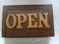 full frontal view of wooden OPEN sign