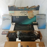 Overall lot showing CX5M console, software boxes, packaging, cables