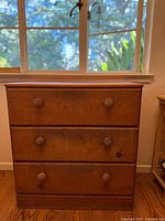 Front view of pine chest showing drawers and pulls