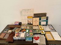Wide view of entire card games and party game lot showing multiple card decks, score pads, rule booklets and cribbage board.