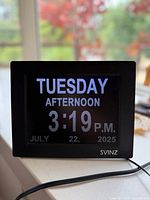 Front view showing display, brand logo and attached power cord